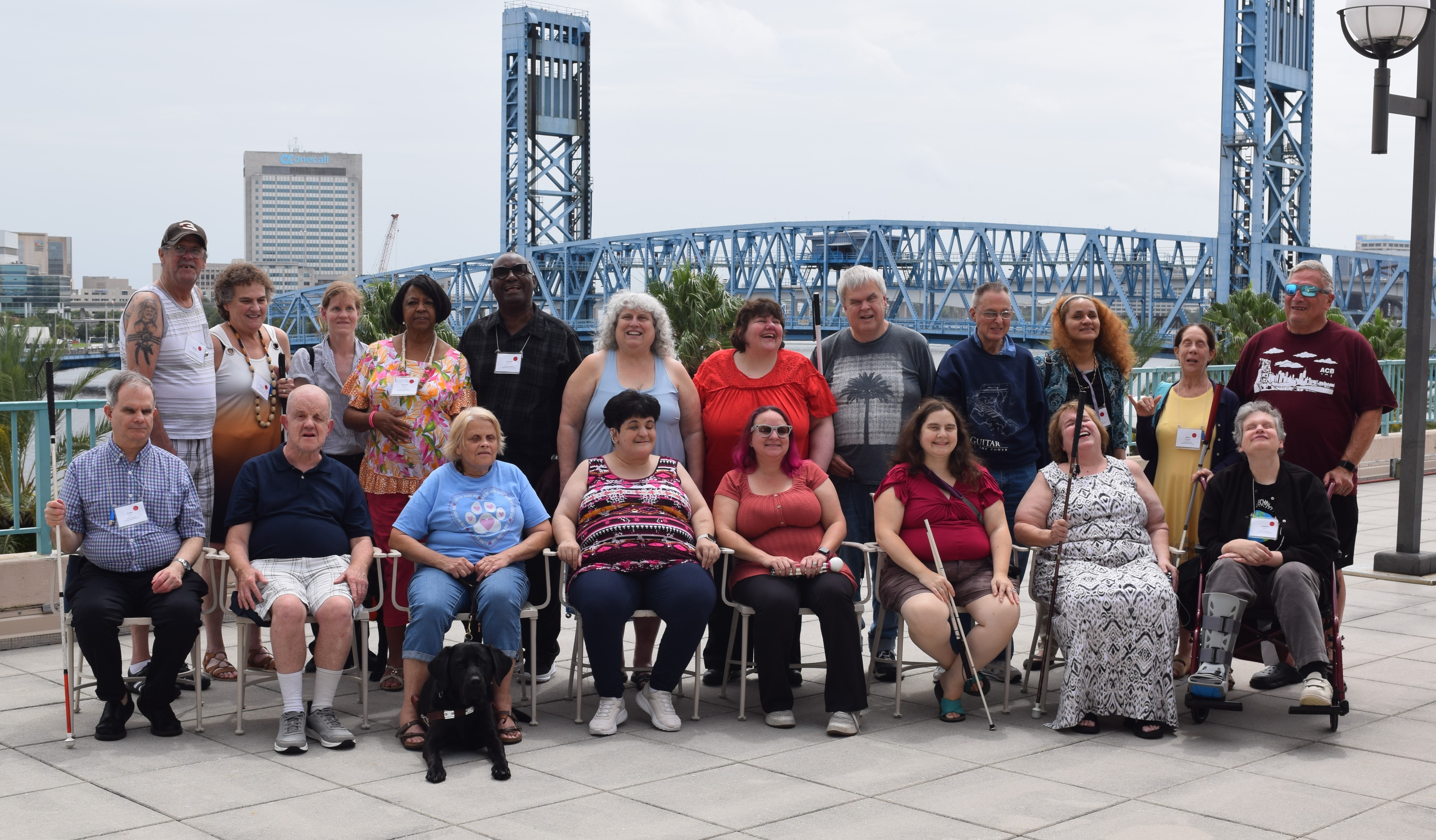 A group photo of Community Events members in front of the Jacksonville Bridge during the 2024 Conference and Convention in Jacksonville, Florida.