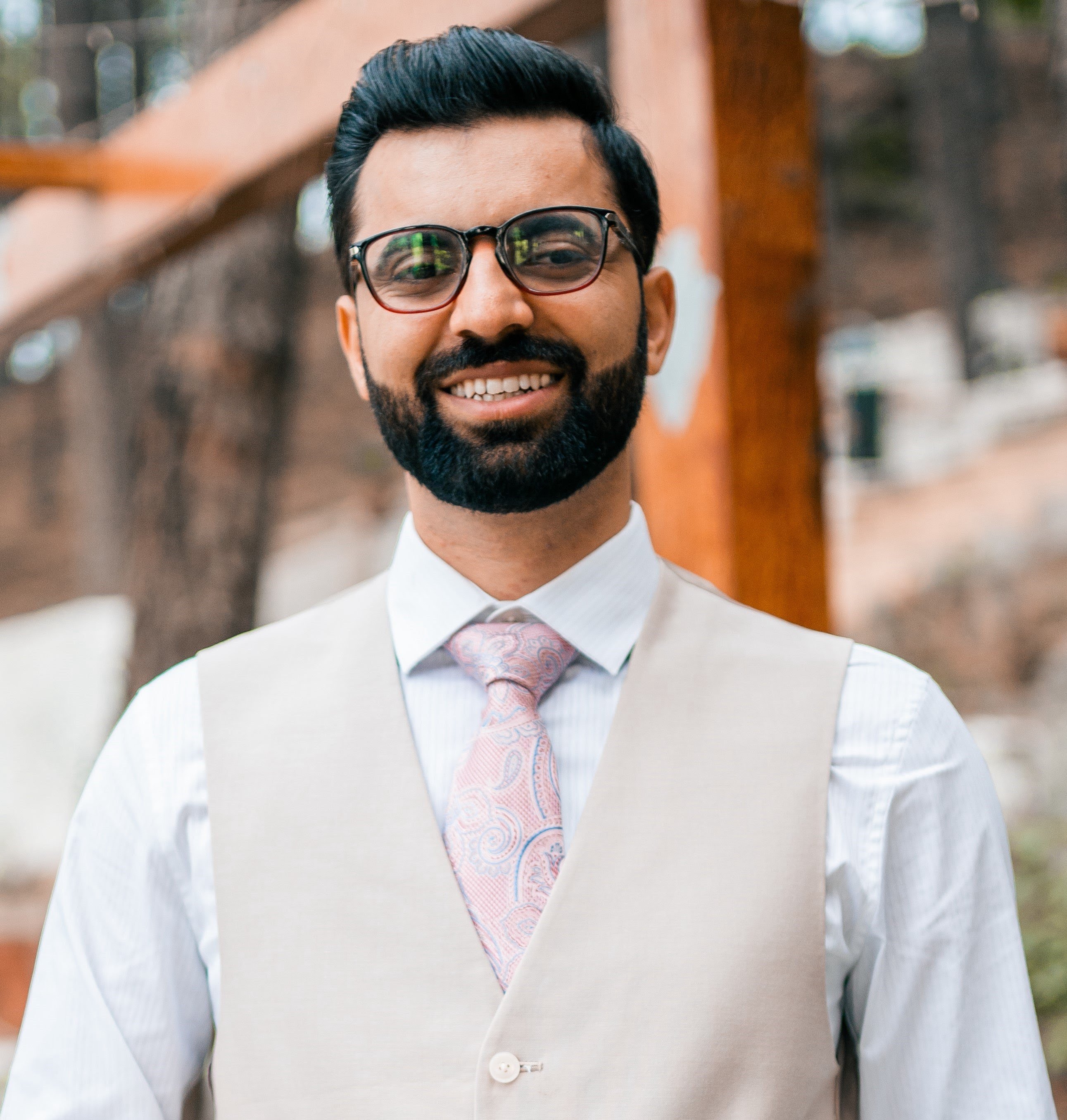 Muhammad Sohaib in white shirt, cream vest and cream colore tie
