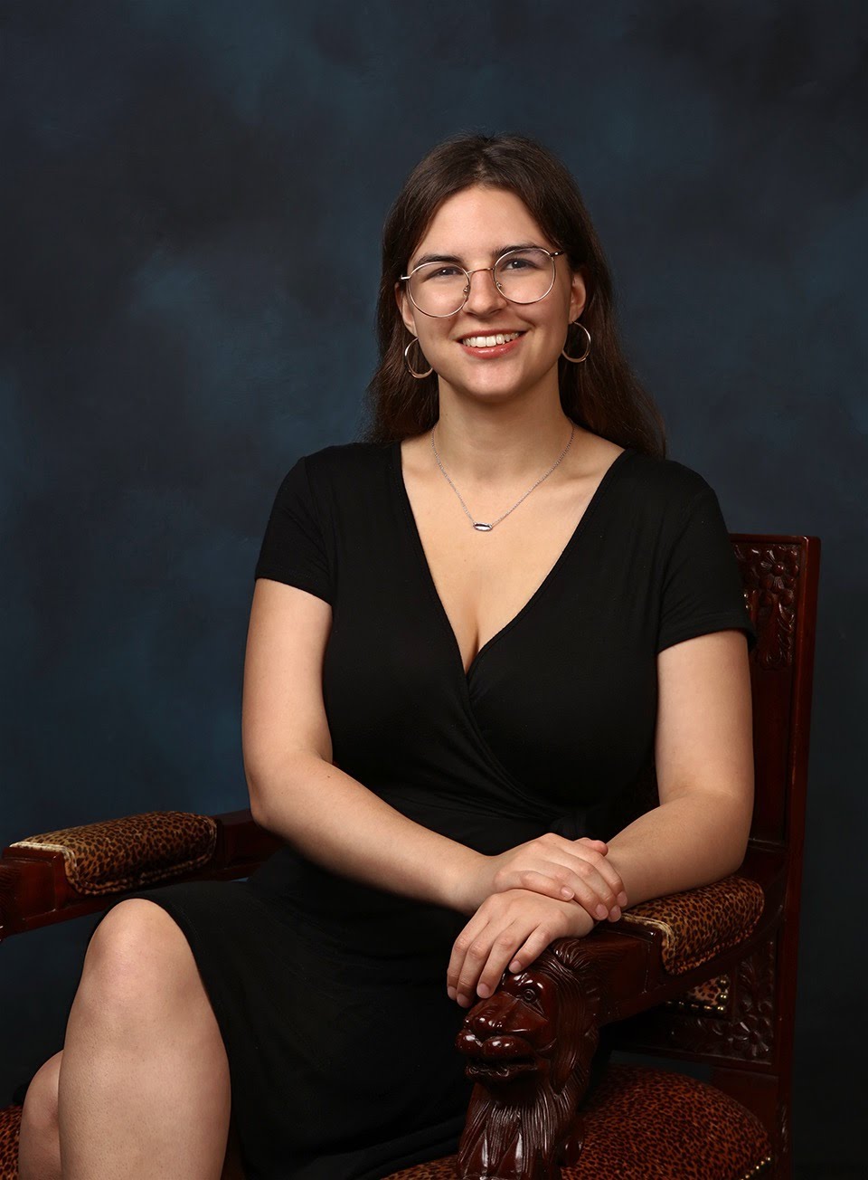 Jenna Sheetz wearing a black dress in a sitting pose
