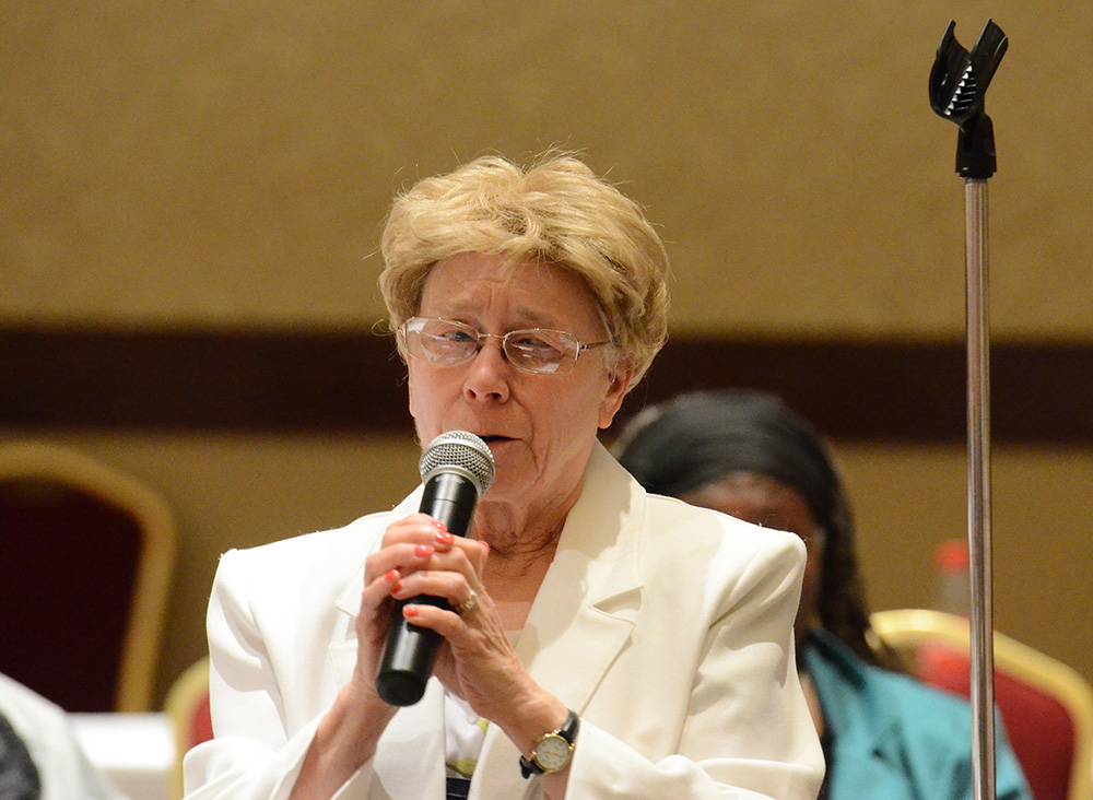 Donna Seliger speaking on a microphone
