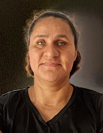 Board Member Lucy Arguijo wearing a dark-colored v-neck top