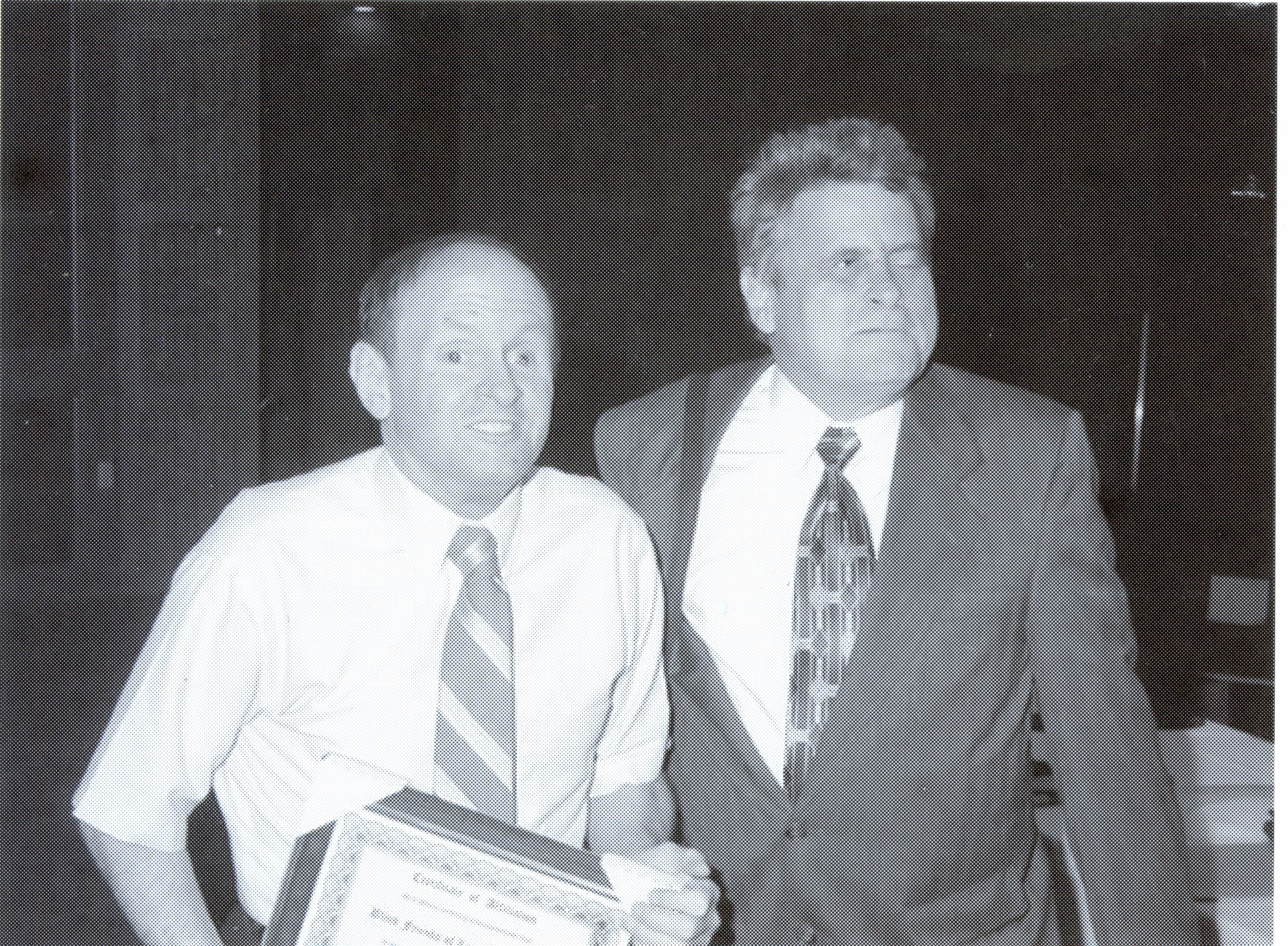 Rob Hill receiving an award from Paul Edwards