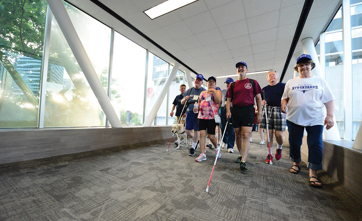 ACB members walking down glassed in walkway